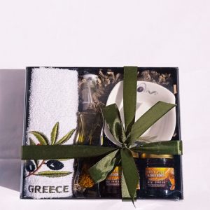 Gift box with honey, olive oil with herbs, towel and bowl