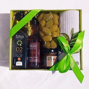 Gift box with olive oil, vinegar, olive paste, olives and towel